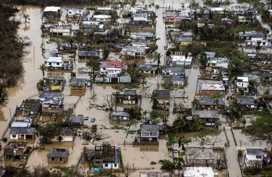 El huracán María azota a Puerto Rico con fuertes inundaciones en muchos lugares de la isla, incluso esta vecindad con casas llenas de aguas turbias.