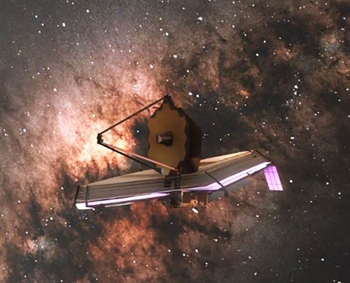 El telescopio espacial James Webb se desplaza a través del espacio estrellado.