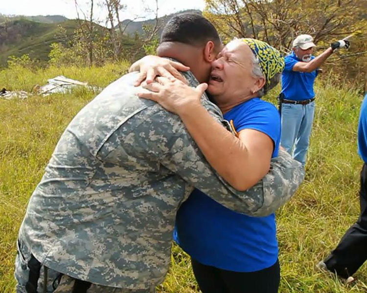 Orocovis, Puerto Rico. Con lágrimas y un abrazo una dama agradece a un militar el haber traído alimentos y agua al barrio donde ella reside. With tears and a big hug, a lady thanks one of the military personal who brought food and water to the barrio where she lives in the mountains of Puerto Rico.