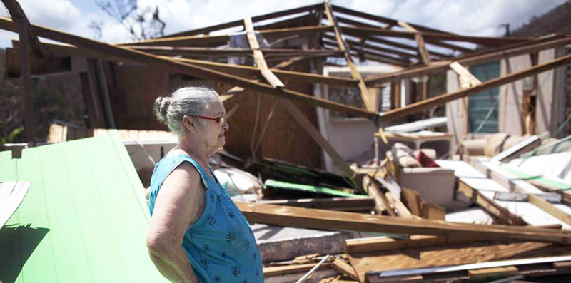 Ceiba, Puerto Rico. Una abuela contempla las ruinas de una casa de madera y zinc edificada por su nieta encima de la casa de concreto habitada por sus abuelos, destrucción hecha por el huracán María.
Ceiba, Puerto Rico. The grandparents, having their own concrete house, allow their granddaughter to build a wood house, with a tin roof, on the top of their concrete house. Such construction is very common throughout Puerto Rico. The upper floor wood structures provide lodging either for family members or renters. While economical to build, this is an example of what happened to tens of thousands of them when hurricane ravaged the island.
