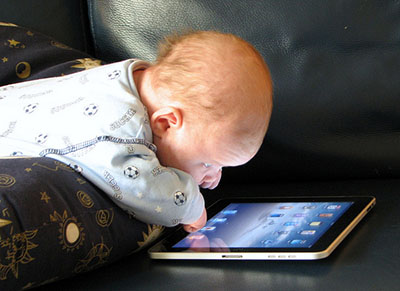 This baby looking at an ipad and touching the screen illustrates a 2016 report by Dewayne and Rita Shappley on their evangelistic work.